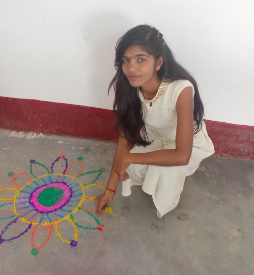 A female student making rangoli