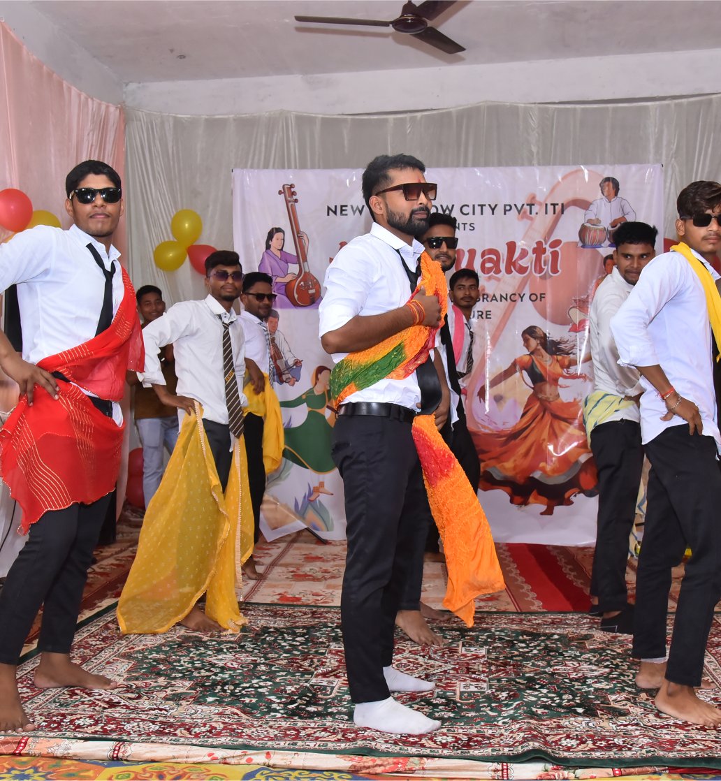 Male students dancing in white-black attire in Abhivyakti
